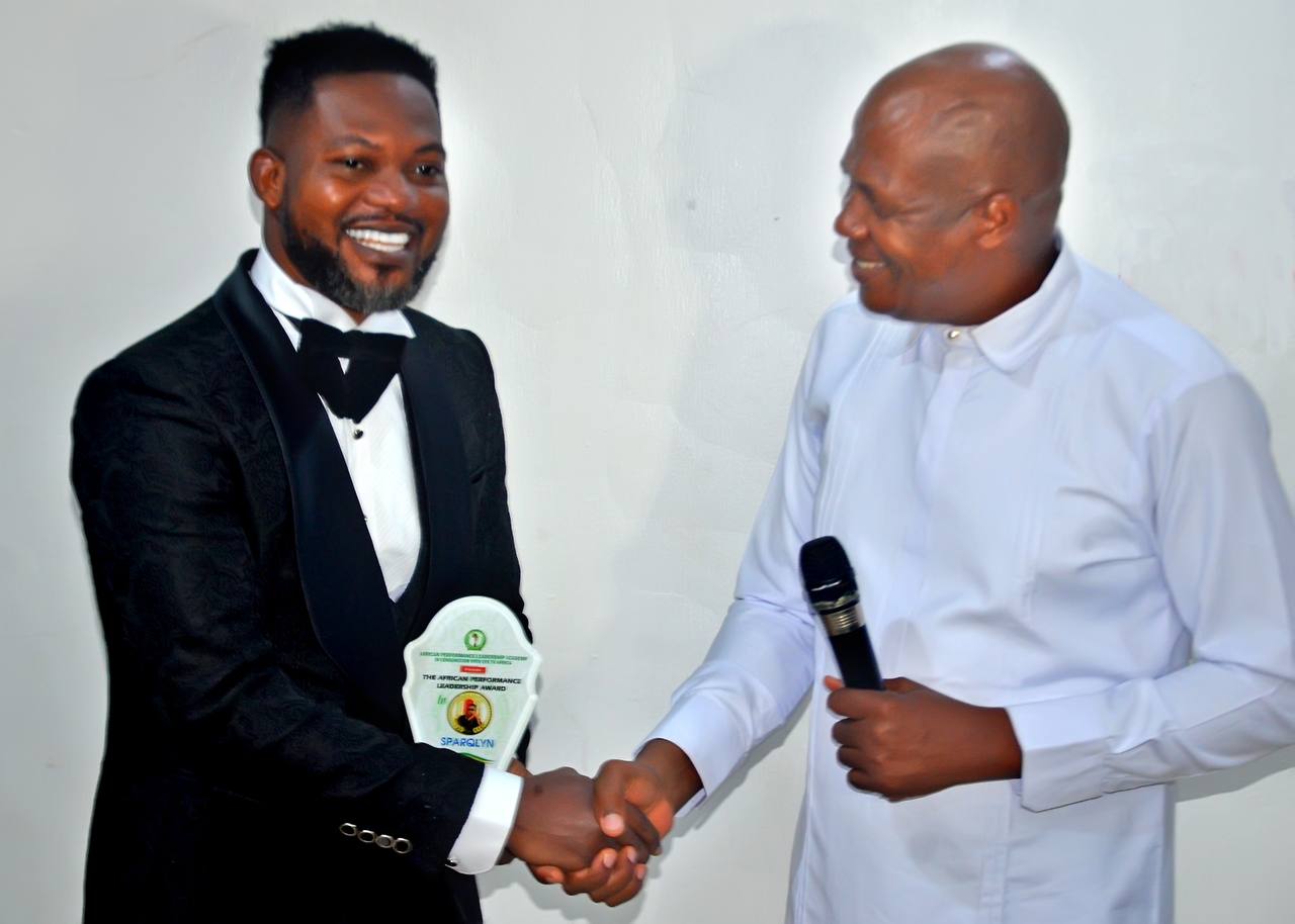 Sparqlyn smiling with trophies